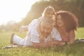 A cute little girl is spending time with her beloved grandfather and grandmather in the park. They had a picnic on the Royalty Free Stock Photo