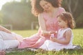 A cute little girl is spending time with her beloved grandfather and grandmather in the park. They had a picnic on the Royalty Free Stock Photo