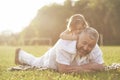 A cute little girl is spending time with her beloved grandfather in the park Royalty Free Stock Photo