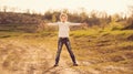 Cute little girl standing with hands to sides on a road Royalty Free Stock Photo