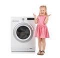 Cute little girl standing near washing machine on white background. Royalty Free Stock Photo