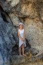 Cute little girl standing between the rocks. Caucasian girl wearing dress and hat. Happy childhood. Summer concept. Traveling with Royalty Free Stock Photo