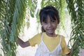 Cute little girl standing and smile in the garden.