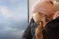 Cute little girl staring through window on a journey Royalty Free Stock Photo