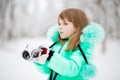 Cute little girl stretches her hand to catch falling snowflakes. Royalty Free Stock Photo