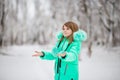 Cute little girl stretches her hand to catch falling snowflakes. Royalty Free Stock Photo