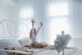 Cute little girl stretching in bed, Royalty Free Stock Photo