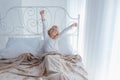 Cute little girl stretching in bed, Royalty Free Stock Photo