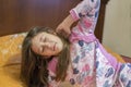 Cute little girl stretching her arms happily with a smile from waking up in her bed. child sleepy yawning in bed. Sleepy little Royalty Free Stock Photo