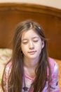 Cute little girl stretching her arms happily with a smile from waking up in her bed. child sleepy yawning in bed. Sleepy little Royalty Free Stock Photo