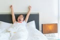 Cute little girl stretching her arms and yawn on bed Royalty Free Stock Photo