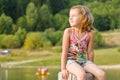 Cute little girl on stump Royalty Free Stock Photo