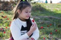 Portrait of a cute little girl in sunny summer day at green nature background. Summer joy - lovely girl blowing dandelion. Royalty Free Stock Photo