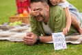 Cute little girl surprising her father, greeting and giving him handmade postcard, daddy and daughter celebrating Father