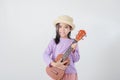 Cute little girl in swimsuit playing ukulele Royalty Free Stock Photo