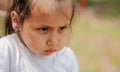 Cute little girl on a swing. sad poor child playing outdoors in summer Royalty Free Stock Photo