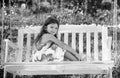 Cute little girl on a swing. Smiling child playing outdoors in summer. Happy mother swinging daughter at the park. Child Royalty Free Stock Photo