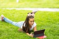 Cute little girl tablet PC in the park Royalty Free Stock Photo
