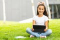 Cute little girl tablet PC in the park Royalty Free Stock Photo