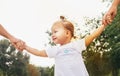 Cute little girl take hands with her relatives people. Walking with kids concept image