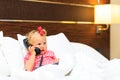 Cute little girl taking on the phone in hotel Royalty Free Stock Photo