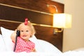 Cute little girl taking on the phone in hotel room Royalty Free Stock Photo