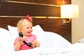 Cute little girl taking on the phone in hotel room Royalty Free Stock Photo