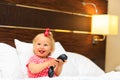 Cute little girl taking on the phone in hotel room Royalty Free Stock Photo