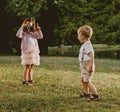 Cute little girl taking a phto of her younger brother Royalty Free Stock Photo