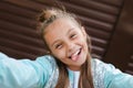 Cute little girl taking a selfie with a mobile phone outdoor. Royalty Free Stock Photo