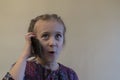 5 year old girl uses a smartphone is talking on the mobile phone and smiling. Girl talking on smartphone. Little kid Royalty Free Stock Photo