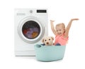 Cute little girl with teddy bear sitting in laundry basket Royalty Free Stock Photo