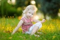 Cute little girl toddler sitting on the grass Royalty Free Stock Photo