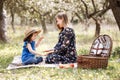 Pregnant mother with daughter in nature. Cute little girl touching her mother`s pregnant belly in summer nature Royalty Free Stock Photo