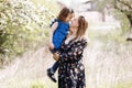 Pregnant mother with daughter in nature. Cute little girl touching her mother`s pregnant belly in summer nature Royalty Free Stock Photo