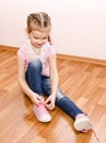 Cute little girl tying her shoes Royalty Free Stock Photo