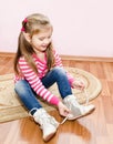 Cute little girl tying her white shoes Royalty Free Stock Photo