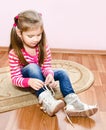 Cute little girl tying her white shoes Royalty Free Stock Photo