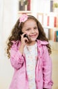 Cute little girl using cell phone Royalty Free Stock Photo