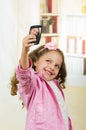 Cute little girl using cell phone taking a selfie Royalty Free Stock Photo