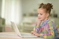 Portrait of cute little girl using laptop Royalty Free Stock Photo