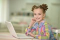 Portrait of cute little girl using laptop at her room Royalty Free Stock Photo