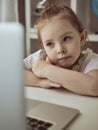 Cute little girl using laptop at home. Education, online study, home studying Kids distance learning Royalty Free Stock Photo
