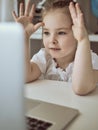 Cute little girl using laptop at home. Education, online study, home studying Kids distance learning Royalty Free Stock Photo