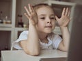 Cute little girl using laptop at home. Education, online study, home studying Kids distance learning Royalty Free Stock Photo