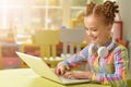 Cute little girl using laptop Royalty Free Stock Photo