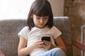 Cute little girl using mobile phone apps, looking at screen Royalty Free Stock Photo