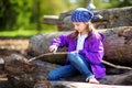 Cute little girl using a pocket knife to whittle a stick for a forest hike Royalty Free Stock Photo