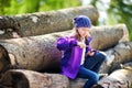 Cute little girl using a pocket knife to whittle a stick for a forest hike Royalty Free Stock Photo