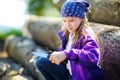 Cute little girl using a pocket knife to whittle a stick for a forest hike Royalty Free Stock Photo